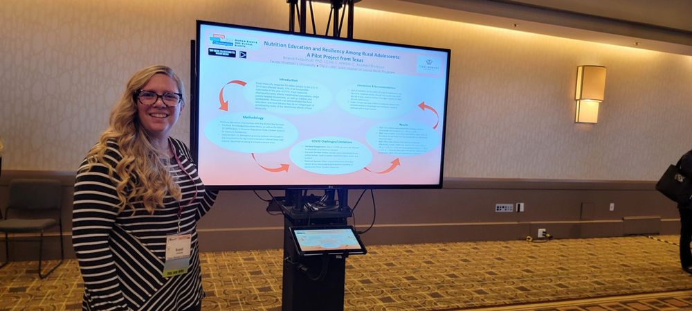 Brandi presenting beside a screen at a conference